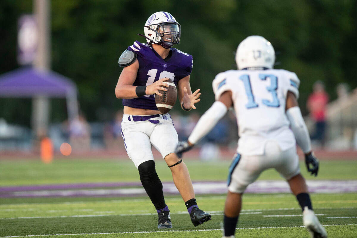 Collinsville’s Ethan Bagwell looks downfield for an open receiver during Friday night’s season opener against Belleville East. The Lancers ultimately prevailed 20-12.