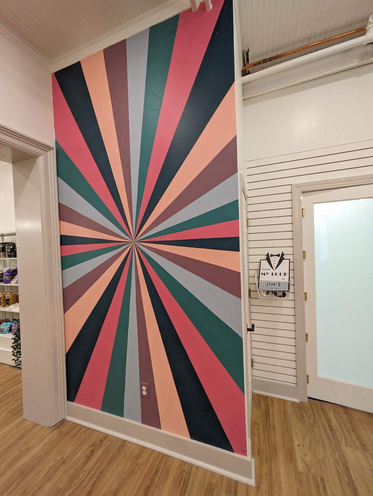 The wall mural provides a fun splash of color at Jim’s Suits & Tuxedos.