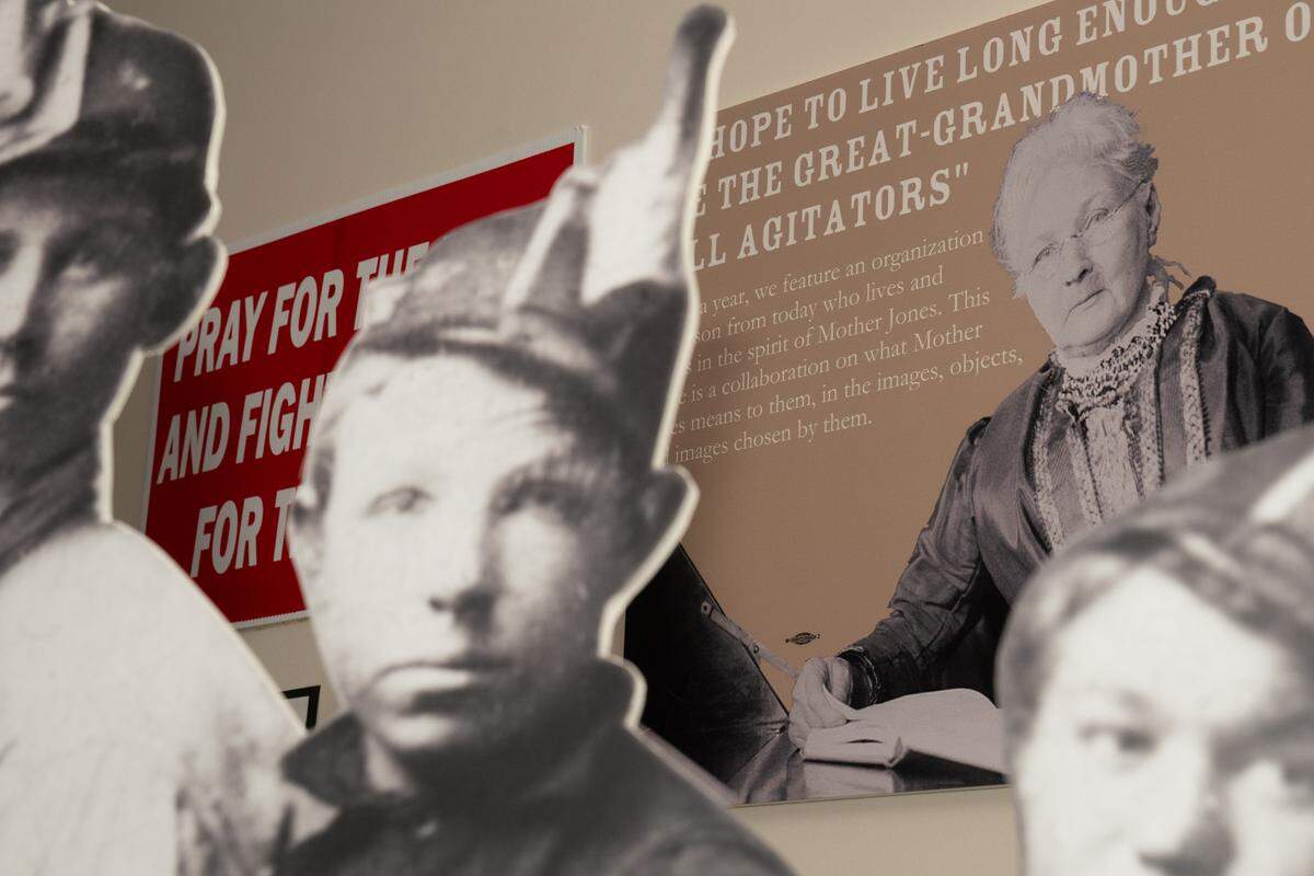 A portrait of Mother Jones stands behind a cardboard cutout of three 20th-century boys working as union miners in the Mother Jones Museum on Sept. 12, 2024. Of all the causes she championed, those of children workers stood at the forefront of Jones’s activism.