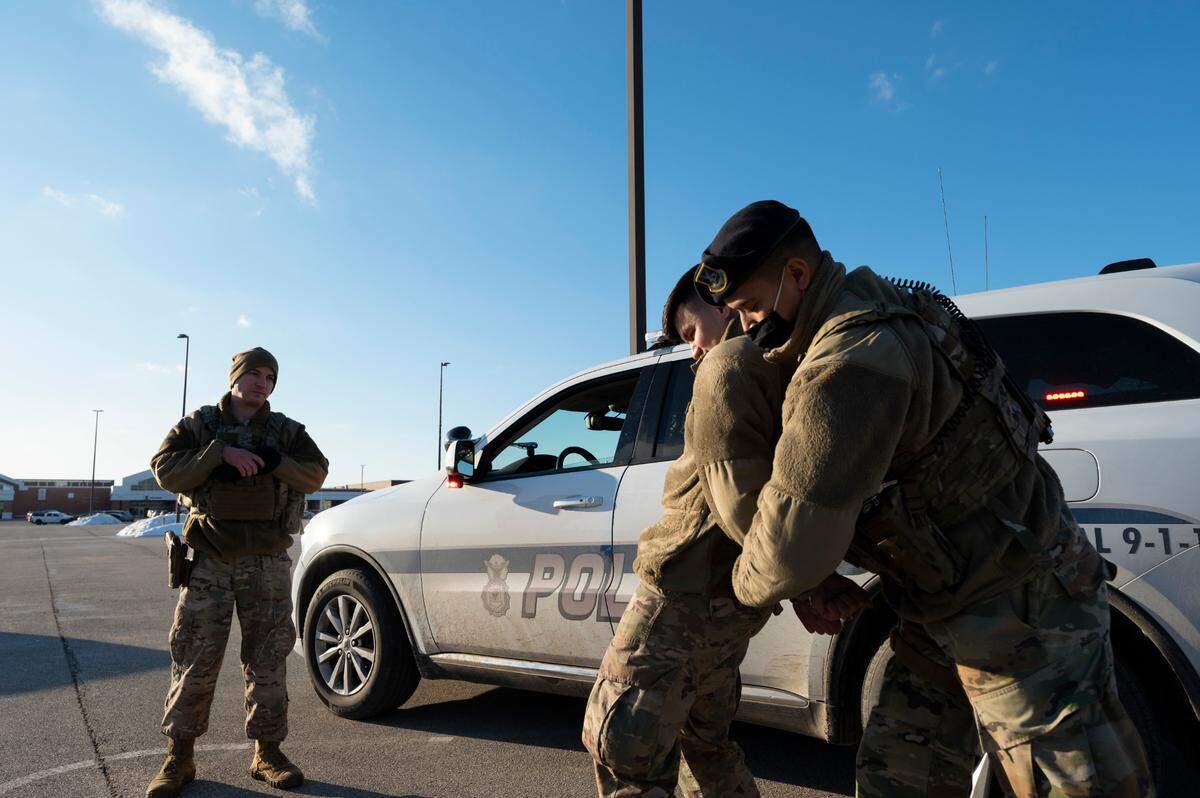 U.S. Air Force Staff Sgt. Shawn Cespedes, 375th Security Forces Squadron non-commissioned officer in charge of confinement, conducts a high-risk traffic stop exercise with Senior Airman Jacob Parker and Airman 1st Class Keith Lautez, 375th Security Forces Squadron entry controllers, on Scott Air Force Base. Exercises like these allow them to hone and sharpen their skills for mission success.