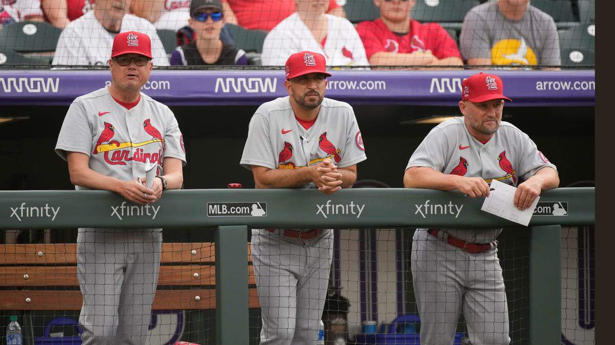 St. Louis Cardinals manager Mike Shildt, bench coach Oliver Marmol and first base coach Stubby Clapp, from left, watch from the dugout in the first inning of the team’s baseball game against the Colorado Rockies in July. Clapp and Marmol are both candidtes to replace Shildt, who was fired by the team last week.