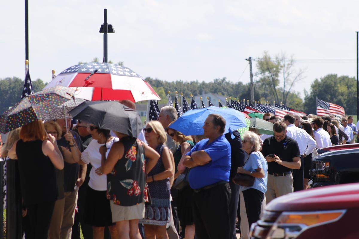 People wait in line for Illinois State Police SWAT Trooper Nicholas Hopkins’ public visitation service to begin Saturday afternoon at Waterloo High School.