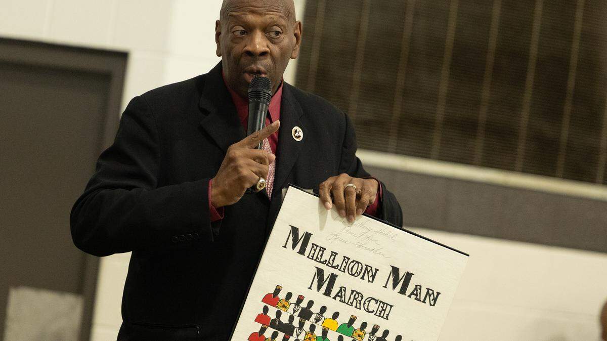 Anthony Shahid, who participated in the first Million Man March in 1995, holds up the original flyer for the event. “There hasn’t been an event like it before or since,” Shahid said.