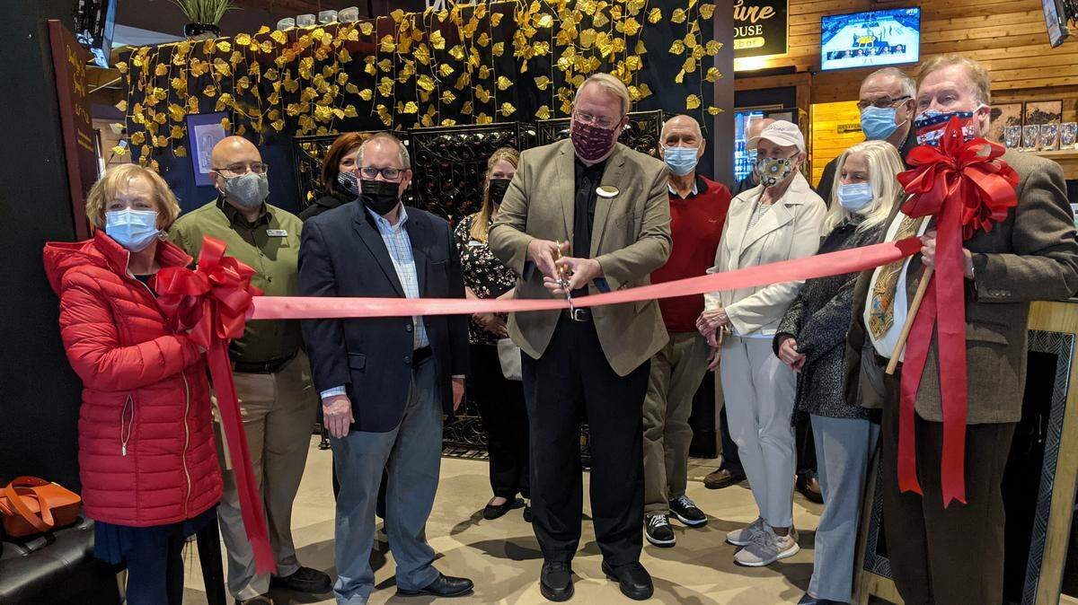 Signature Tap House owner Brandon McGraw cuts the ribbon at the restaurant’s grand reopening event on April 20.