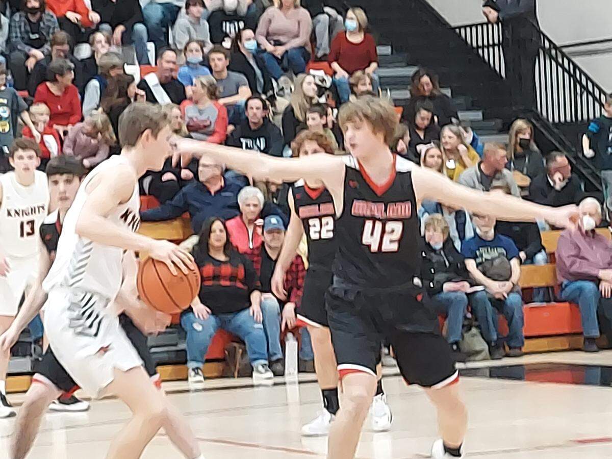 Highland junior forward Gunnar Mackey looks to cut off Triad’s Jake Stewart during a Mississippi Valley Conference game Tuesday, Feb. 8, at Triad High School. Mackey and the Bulldogs ultimately defeated the rival Knights 39-30.