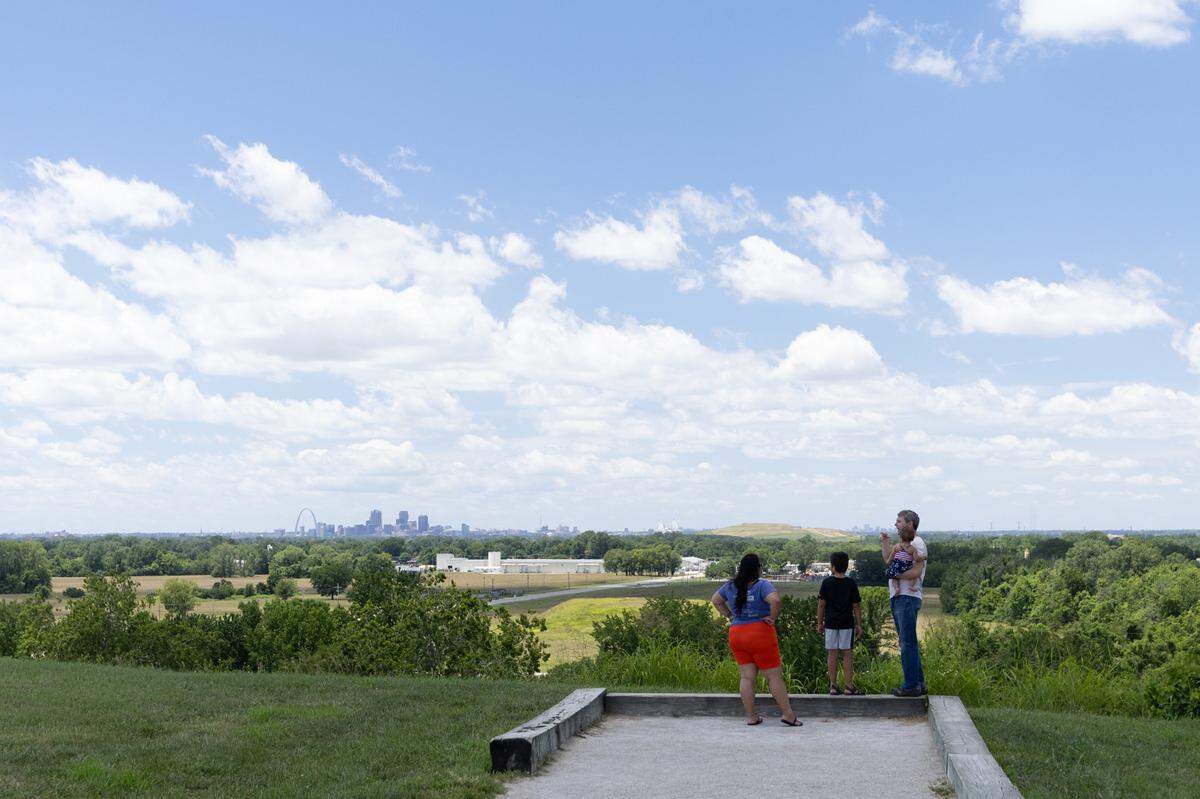 A family reads a plaque atop Monk’s Mound at Cahokia Mounds State Historic Site July 5.