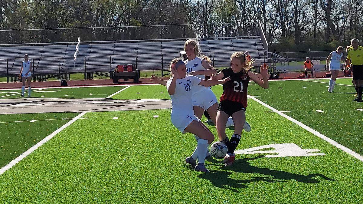 Mater Dei’s Brianna Noud and Amelia Beer battle Highland’s Alyson Pace for a loose ball just past midfield during a nonconference game Wednesday, April 12, at Highland High School. Pace and the Bulldogs have completed the regular season and now will open regional action Tuesday, May 16.