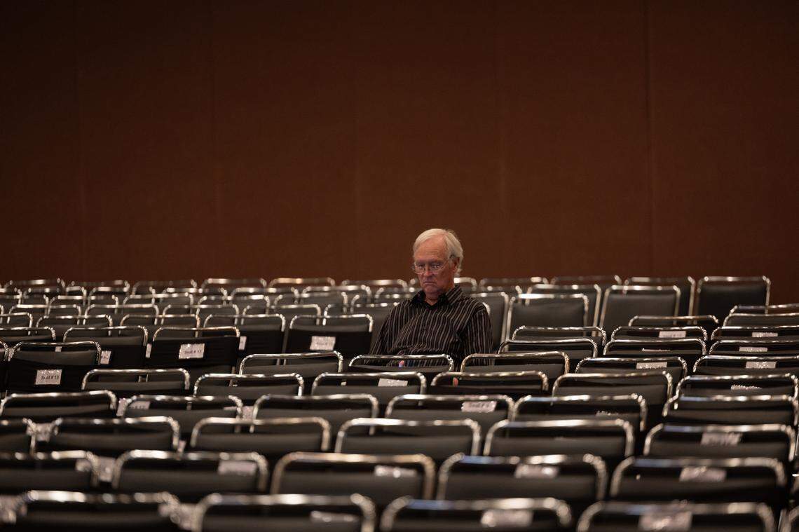 A man waits for the Elvis tribute performances to begin an hour before their scheduled start.