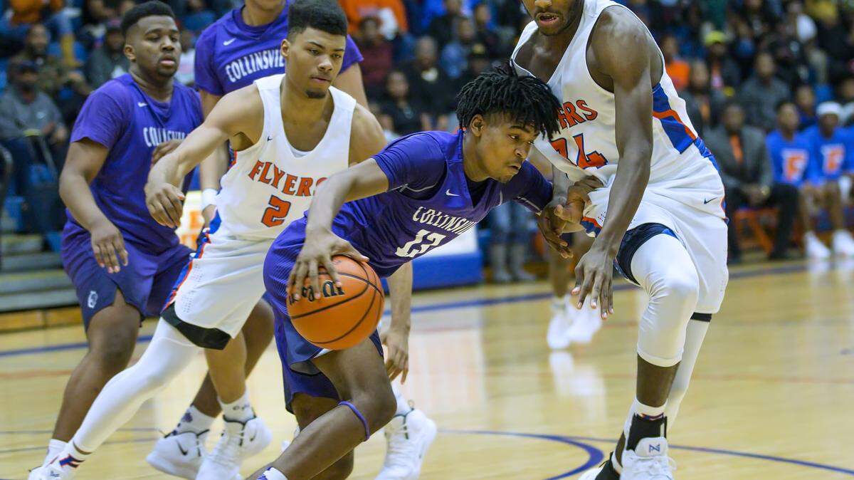 Collinsville Ray’sean Taylor drives against East St. Louis Terrance Hargrove during a conference game at East St. Louis High School. The two teams could face each other at the 35th annual Collinsville Holiday Tournament this week.