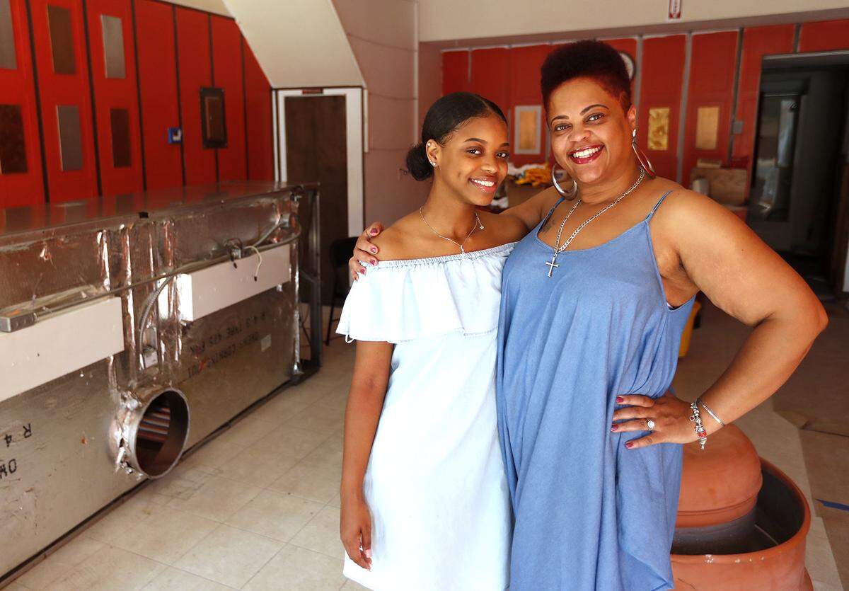 Christi Robertson and her daughter Christin stand in what will be the dining room of the C and C Food for Your Soul restaurant in Belleville.
