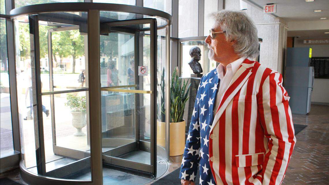 In this July 29, 2014, file photo, Bob Romanik waits on the first floor of the St. Clair County Building for county court in a red, white and blue Uncle Sam costume, minus the top hat, as a way of reminding the public, “If they can do this to me, they can do this to you.”