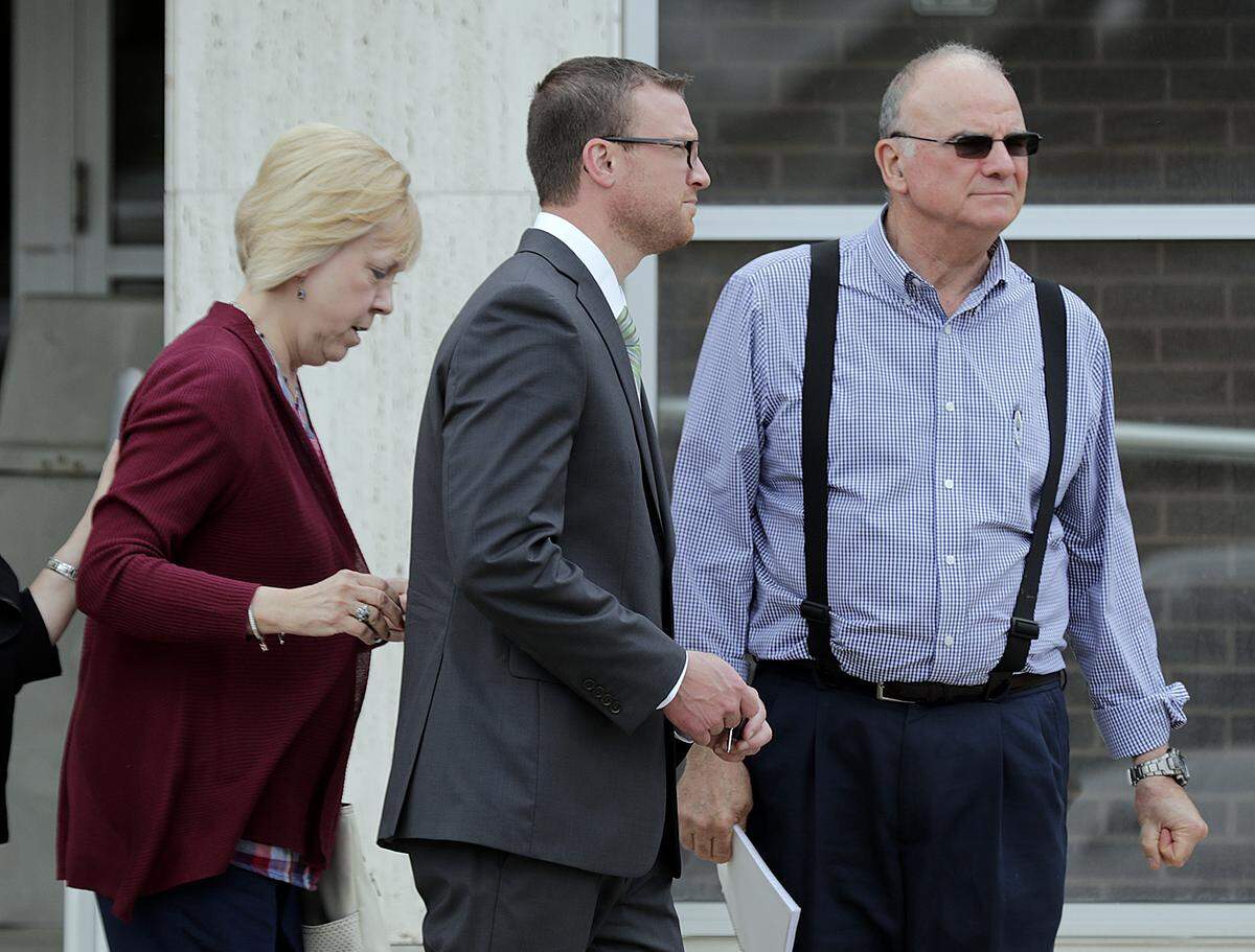 Michael Burgund (center) walks with supporters during a trial break Thursday outside the Madison County Criminal Justice Center in Edwardsville. Burgund is on trial on charges of molestation of two toddlers.