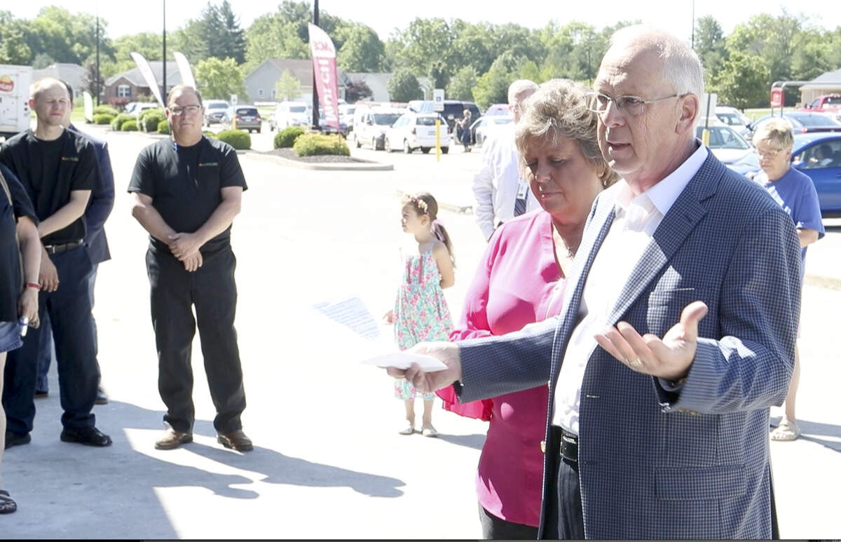 Joe Koppeis speaks during the ribbon-cutting for Freeburg Country Mart, which opened Tuesday off State Street. He's joined by his business partner, Kathy Nordike.