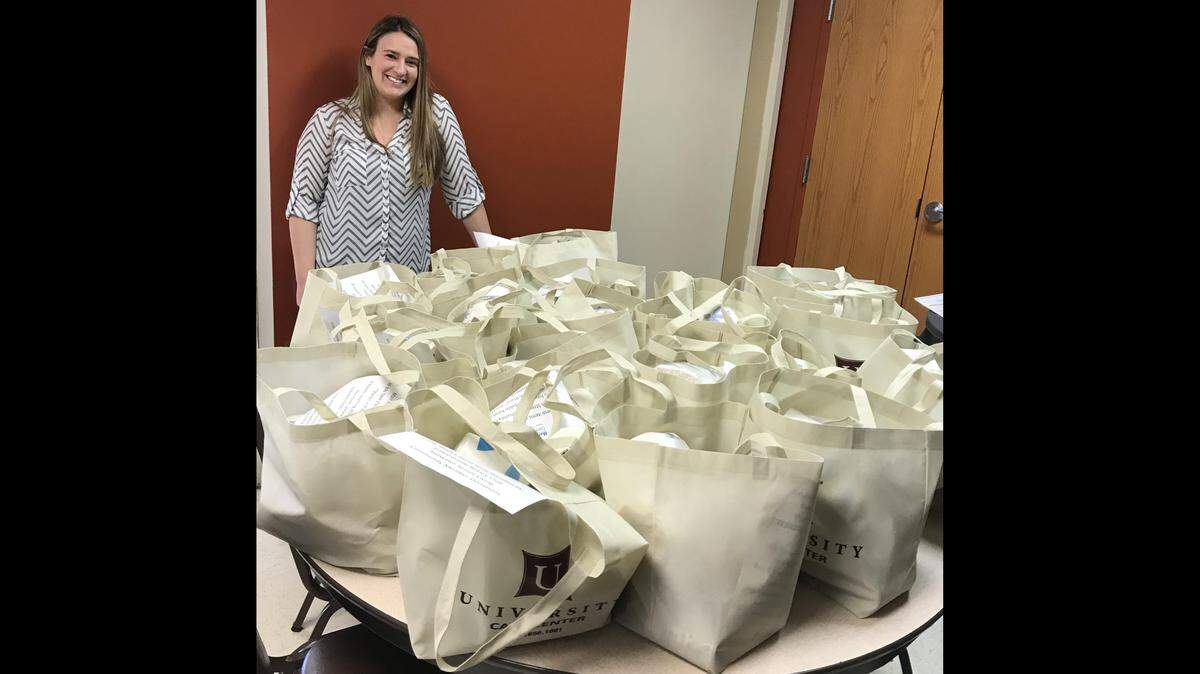 Angela Fraley, nutrition and health program coordinator at Main Street Community Center in Edwardsville, checks on non-perishable food bags going out to 40 homebound residents.
