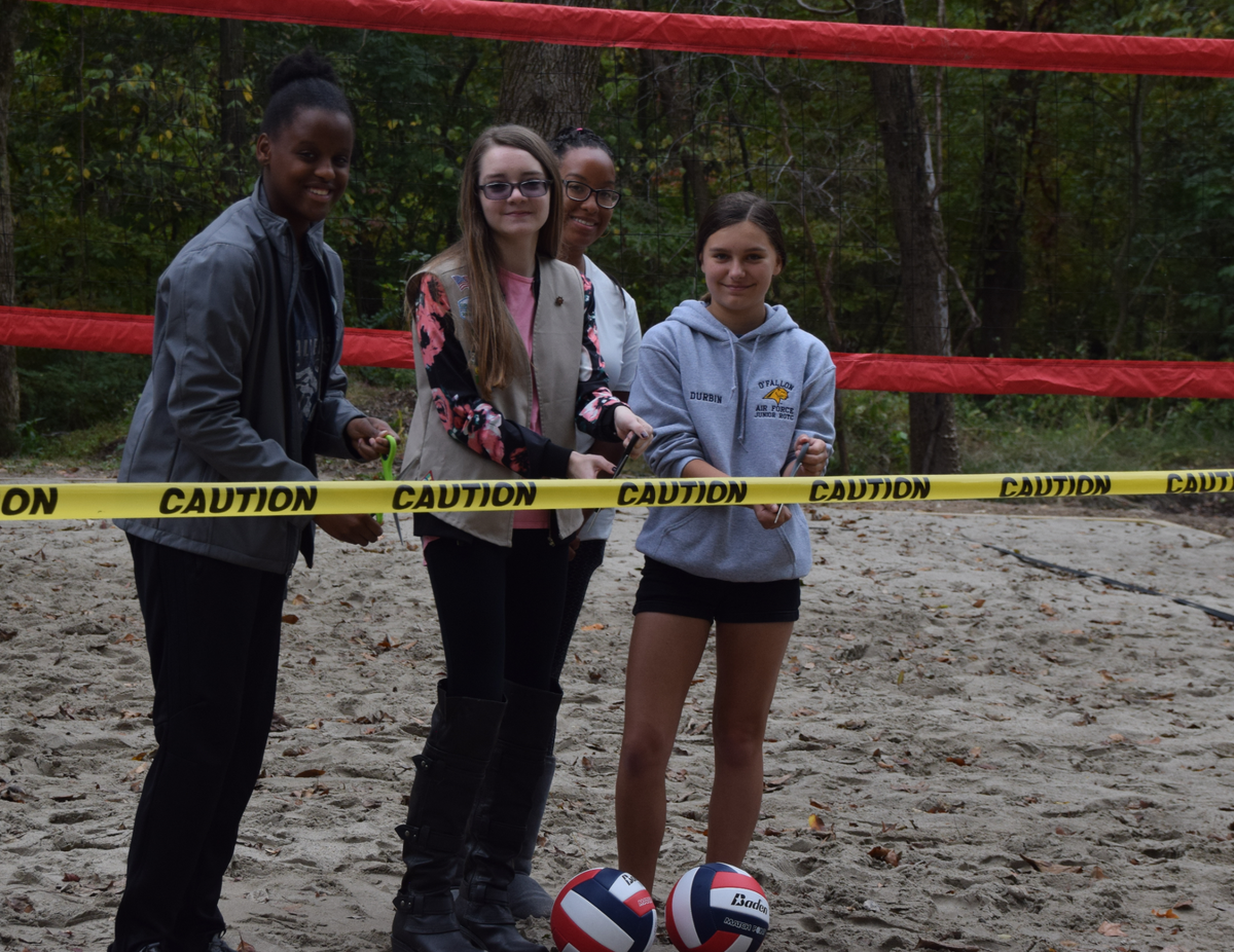 Girl Scouts in Belleville Troop 530 cut the ribbon on a new sand-volleyball court that they built in 2019 at Camp Torqua near Edwardsville. They are, left to right, Kameron Gresham, Creighton Endsley, Tiarna Reid (adviser) and Bella Durbin.