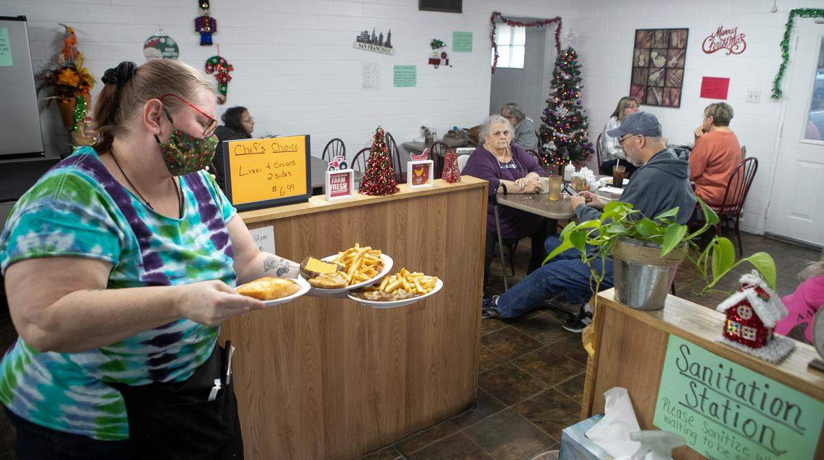 Waitress Kim Perry delivers lunch to customers dining inside at the Route 13 Diner, which was previously called Moore’s Restaurant in Belleville. The restaurant is continuing to defy inside dining restrictions despite being order to close.