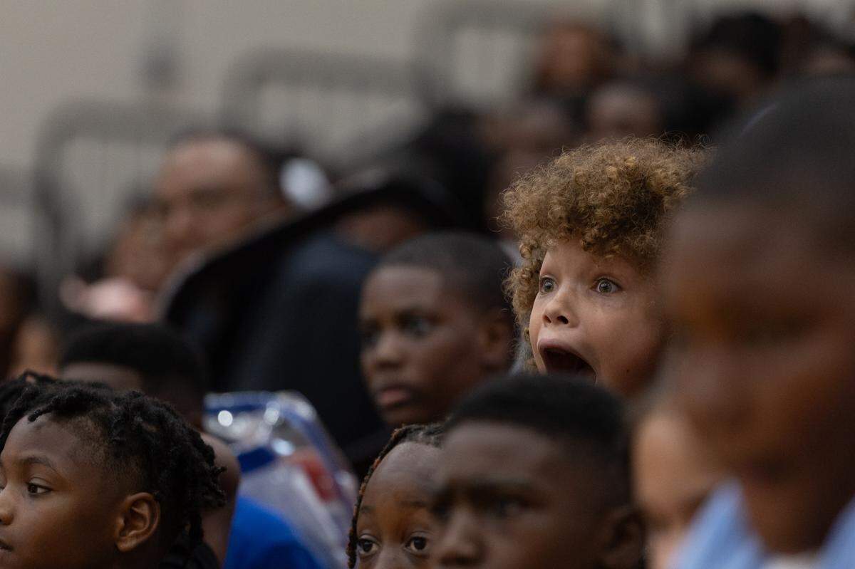 A middle-school crowd reacts to aerialists performing a 720 routine at Mason-Clark Middle School on Aug. 14, 2024.