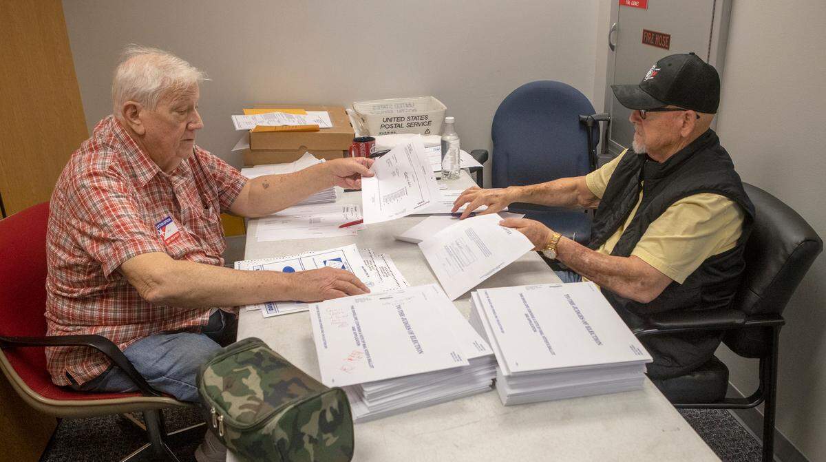 Election judges John Huff, Democrat and John Hubbard, Republican, verify vote by mail ballots at the St. Clair County Clerk’s office. Approximately 13,000 mail-in ballots had been received as of Thursday, November 3rd. St. Clair County Clerk Thomas Holbrook commented that vote by mail was up in this election in comparison to the 2018 election, that also included the governor’s race, because Illinois voters can permanently register to vote by mail.