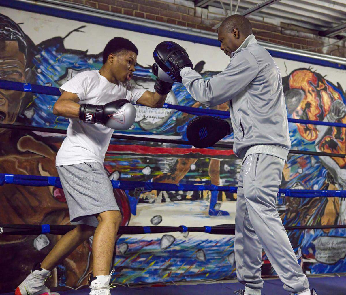 Promising lightweight boxer Daniel Nolan of Cahokia, left, trains with former East St. Louis Golden Glove Champion Arthur “Flash” Johnson. Nolan has been training at the Flash Boxing and Activity Center in East St. Louis — owned by Johnson — the past two years.
