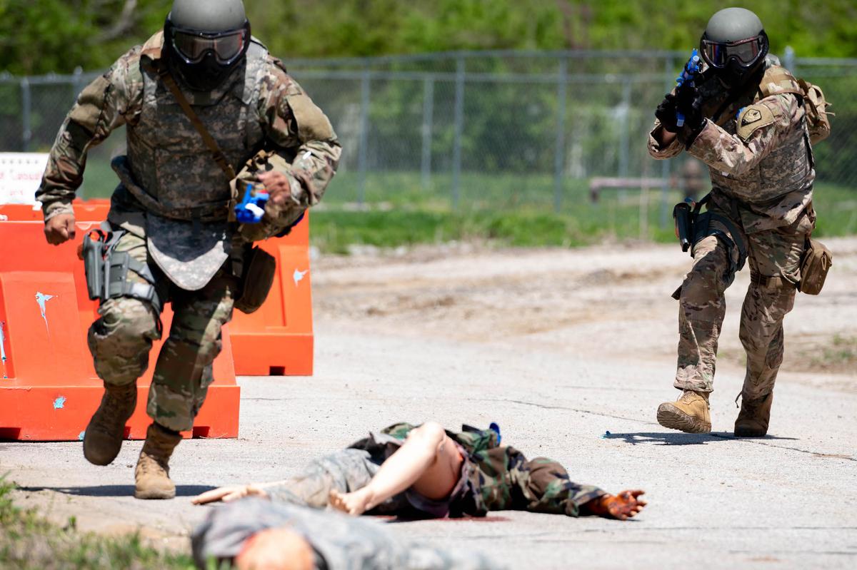 Members of Team Scott sprints to mannequin utilizing knowledge from a Tactical Combat Casualty Care class on Scott Air Force Base. TCCC was created to help prevent combat casualties by providing trauma stabilization techniques allowing troops to receive life-saving treatment.