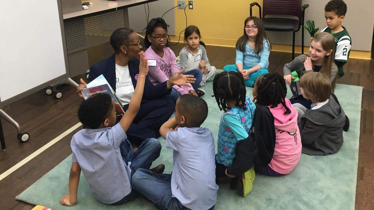 Annetta Works-Sallee reads "Justice Makes a Difference: The Story of Miss Freedom Fighter, Esquire" to a group of children at the O'Fallon Public Library during a story hour on March 24.
