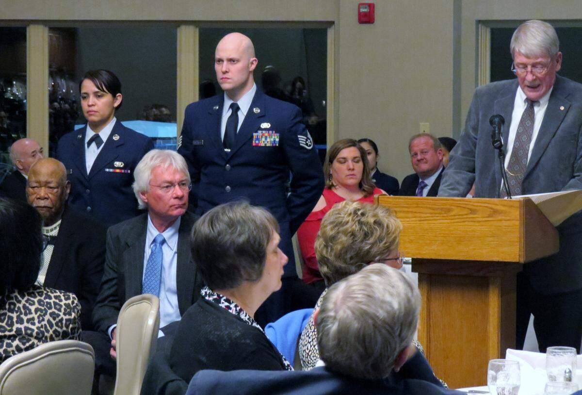 Charles “Chuck” Poettker, seated in blue tie, is honored along with other local veterans at the Belle-Scott Dinner at Scott Air Force Base in 2018.