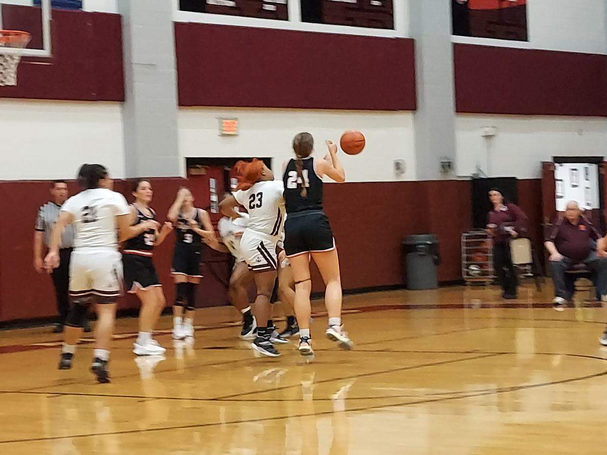 Belleville West senior forward Ja’Mya Company and Highland junior post Larissa Taylor battle for a loose ball during a non-conference game Monday, Dec. 5, at Belleville West High School. The Lady Bulldogs ultimately posted a 57-44 victory.