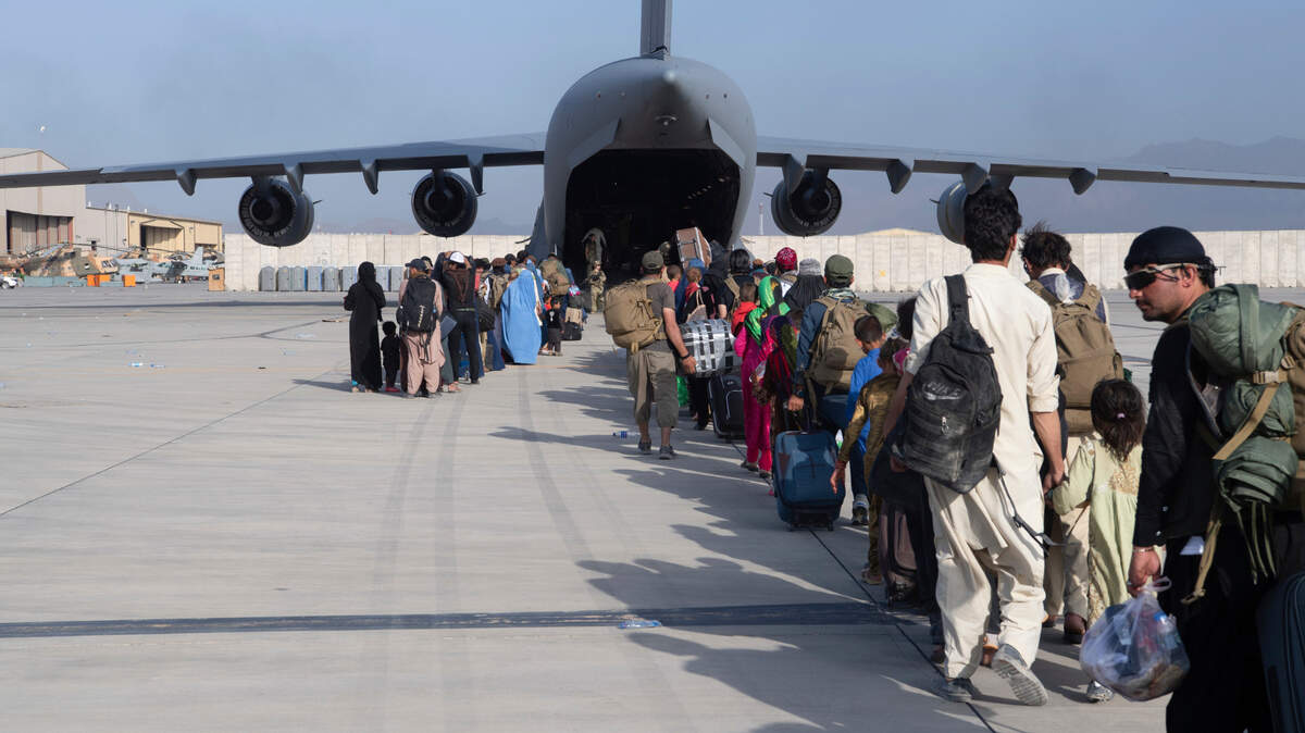 U.S. Air Force loadmasters and pilots assigned to the 816th Expeditionary Airlift Squadron, load people being evacuated from Afghanistan onto a U.S. Air Force C-17 Globemaster III at Hamid Karzai International Airport in Kabul, Afghanistan, Tuesday. U.S. Transportation Command at Scott Air Force Base coordinates the logistics of the military’s evacuation of Kabul. (Master Sgt. Donald R. Allen/U.S. Air Force via AP)