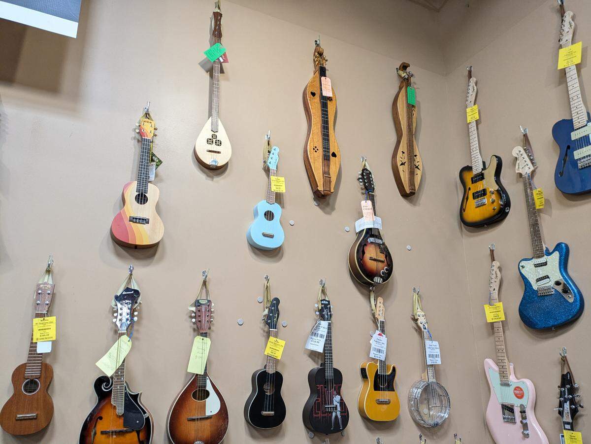 A display of ukuleles, mandolins, dulcimers and other string instruments