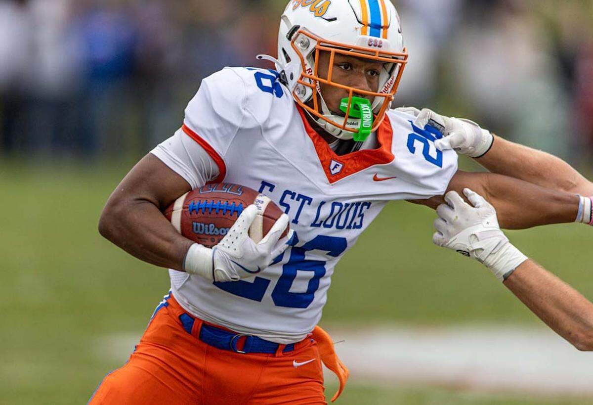 East St. Louis’ Ahmad Coleman carries against Glenwood during Saturday’s IHSA Class 6A second-round playoff football game.