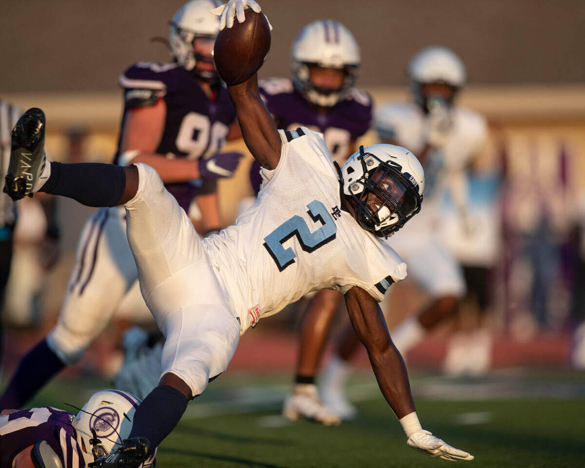 Belleville East’s Markevious Curiton carries the ball during Friday night’s season opener against Collinsville. The Lancers ultimately prevailed 20-12.
