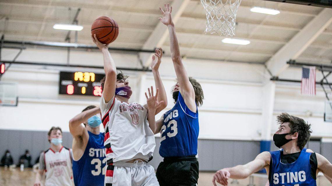Nate Hall with the Collinsville Hawks goes up for a shot against Nashville Sting defenders during a game at the Center St. Louis Sports Complex. The CDC recommended that schools cancel activities like sports and band in areas with high levels of COVID transmission, but will they?