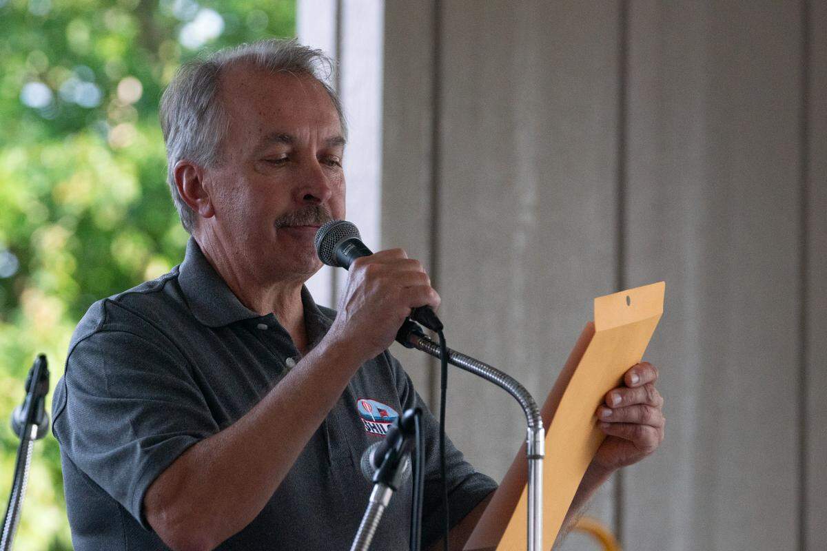 Mayor Robert Weilmuenster dedicates a plaque to the late businessman and bluegrass musician. “This was George’s backyard,” Weilmuenster said, “he loved playing here.”