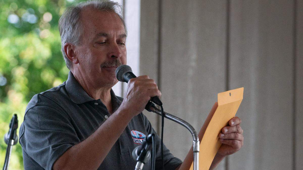 Mayor Robert Weilmuenster dedicates a plaque to the late businessman and bluegrass musician. “This was George’s backyard,” Weilmuenster said, “he loved playing here.”