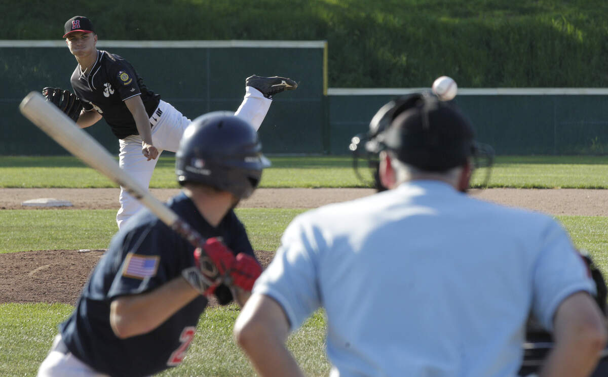 Connor Pinsker delivers a pitch in Highland’s game on Wednesday at Alton.