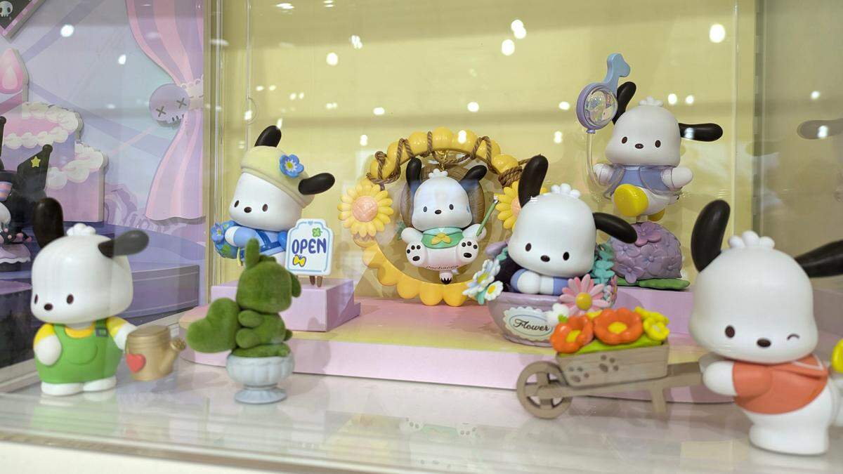 A collection of figurines featuring Pochacco, a character by Sanrio, which includes Hello Kitty