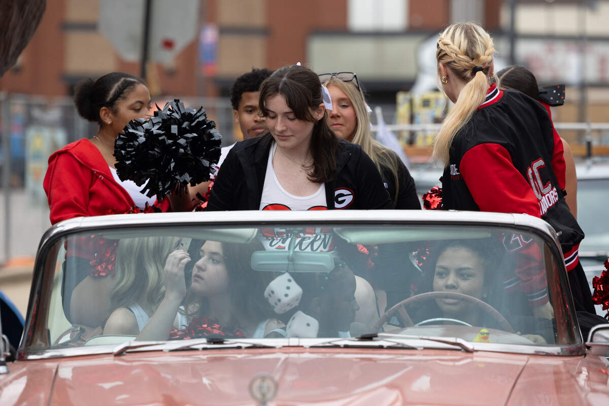 Cheerleaders for Granite City pile into a classic car during the Route 66 Centennial Caravan’s 17th stop along their cross-country trip through Granite City.