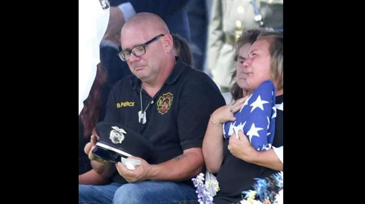 Brian Pierce Sr. and Tammy Pierce attend the internment for their son, Brian Pierce Jr., a Brooklyn Police officer who was killed on the McKinley Bridge on Aug. 4 when he was struck by a motorist fleeing police.