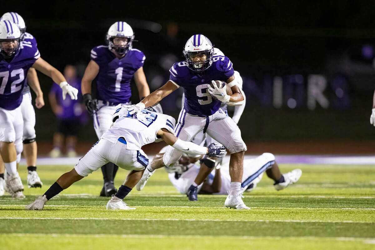 Collinsville’s Jerry Richardson carries the ball during Friday night’s season opener against Belleville East. The Lancers ultimately prevailed 20-12.