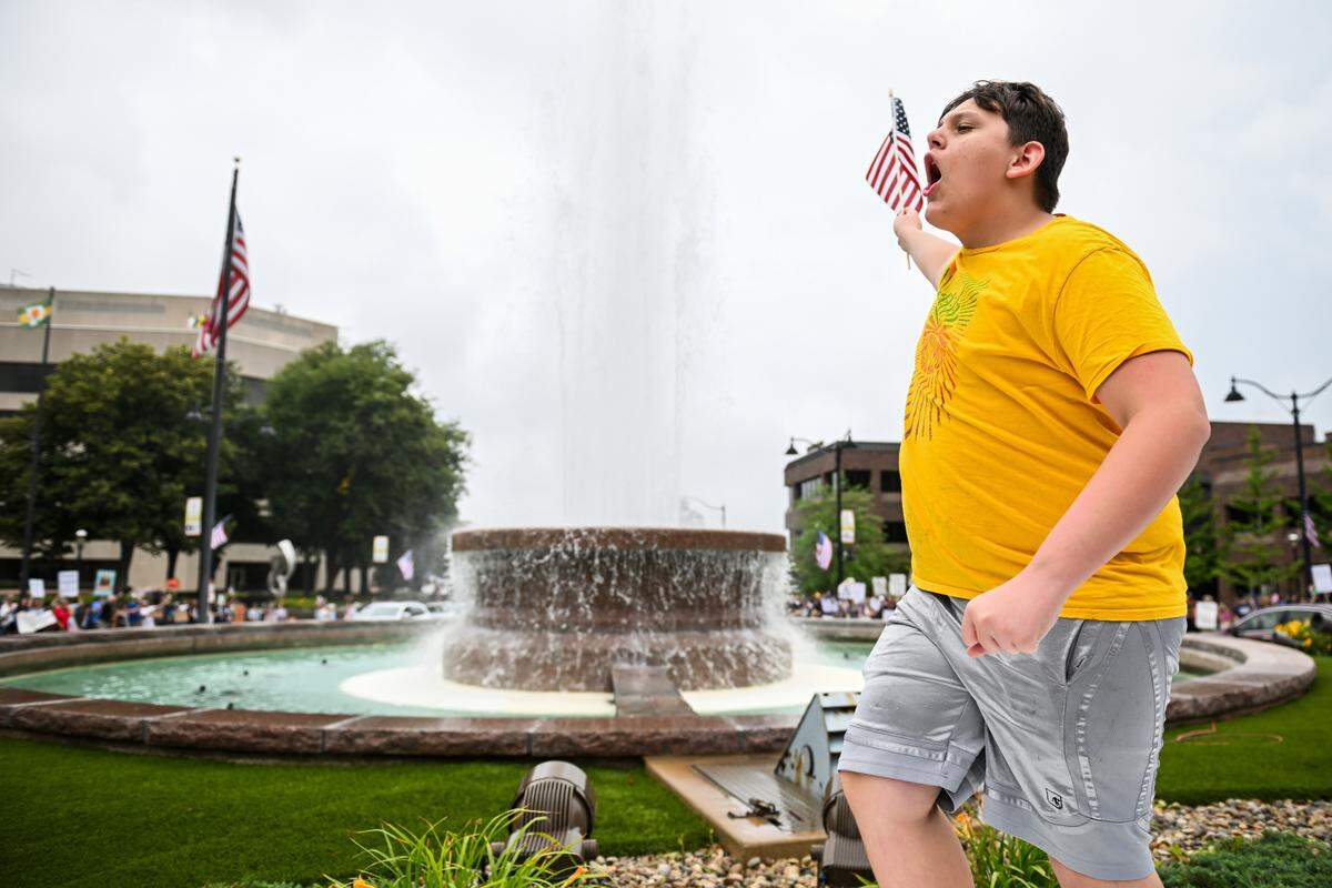 A protester climbed onto the Veterans Memorial Fountain in Belleville’s Public Square and chanted “Dump Trump” during the “No Kings” protest Saturday, June 14, 2025.