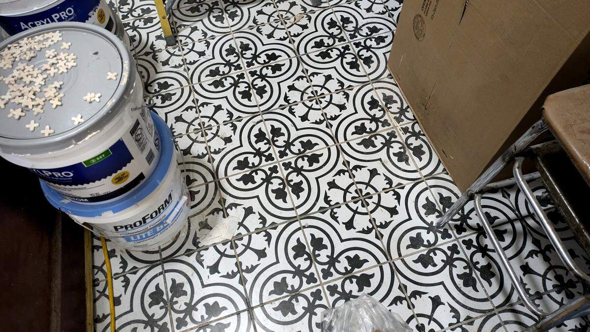 Vintage-style patterned tiles can be found in the bathrooms and behind the main bar at The Harp Pub.