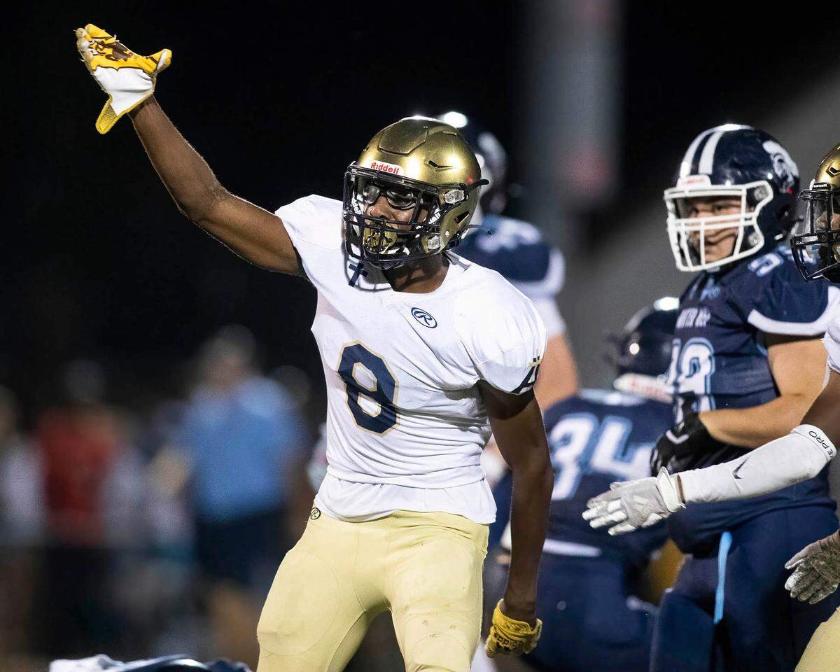 Althoff’s Taylor Powell signals first down after catching a pass on a touchdown drive during Friday night’s non-conference game against Mater Dei. The Crusaders ultimately posted a 13-7 road victory.