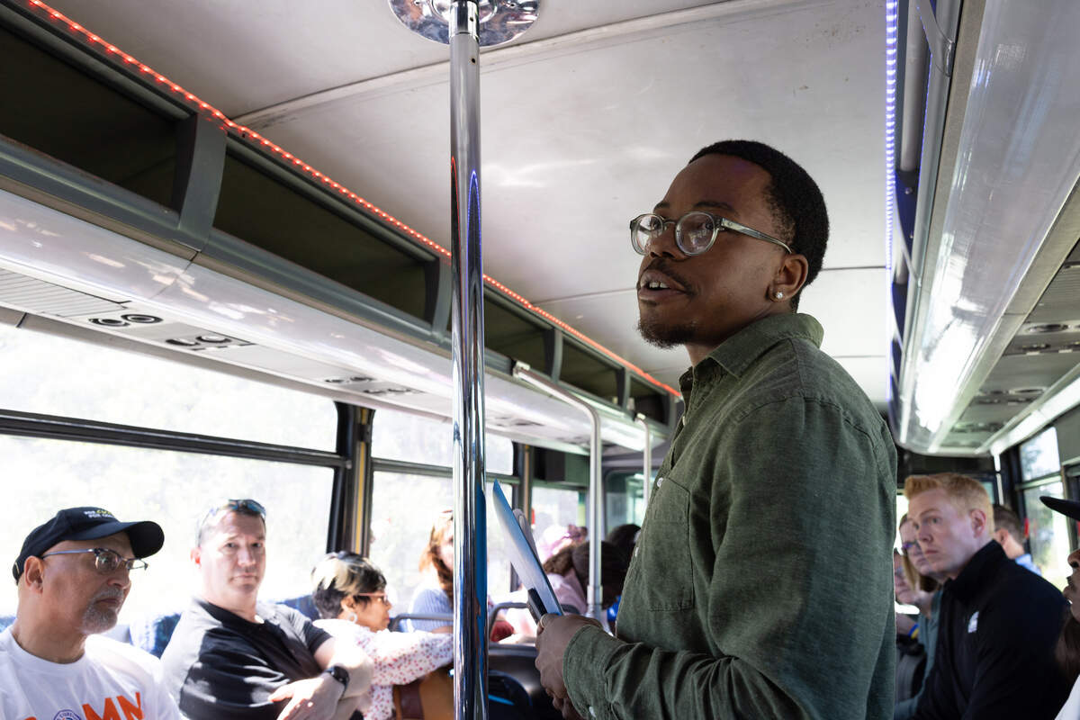 Jalen Williams, from the group Parents United for Change, provides context for a site on the tour.
