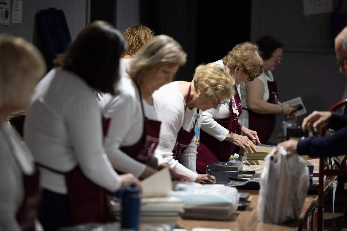 Members of the Belleville Memorial Hospital Auxiliary help with purchases during the 2026 Book Bazaar at the Belle-Clair Fairgrounds on Thursday.