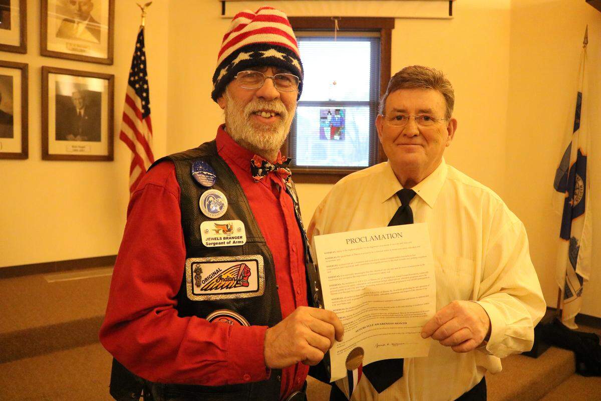 During the Highland City Council meeting on April 16, a local chapter of the Brotherhood Aimed Toward Education (ABATE) of Illinois's sergeant at arms Jewels A. Brangor stands with Mayor Joe Michaelis after the proclamation for Motorcycle Awareness Month.