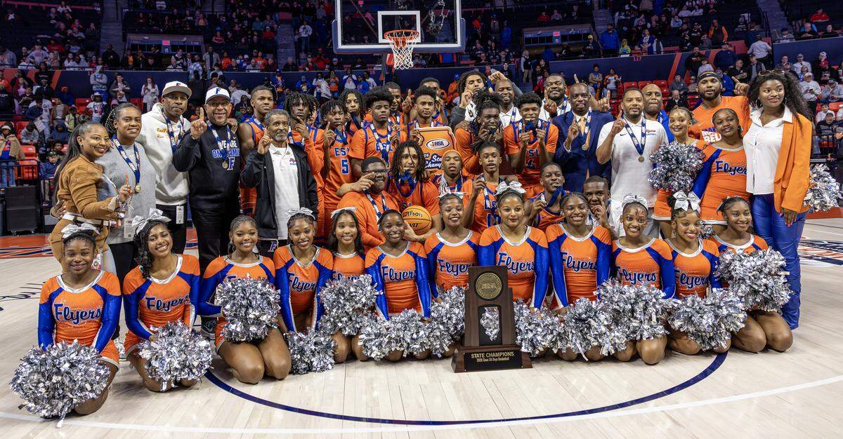 East St. Louis players, cheerleaders, coaches and fans celebrate after winning the IHSA 3A championship against Deerfield.
