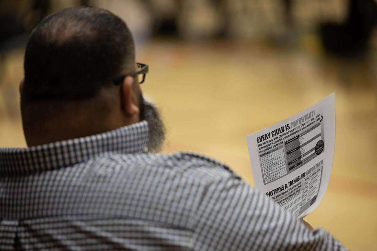 A school board meeting attendee at Grant Middle School in Fairview Heights on March 26, 2024, holds a pamphlet saying ‘EVERY CHILD IS IMPORTANT!’