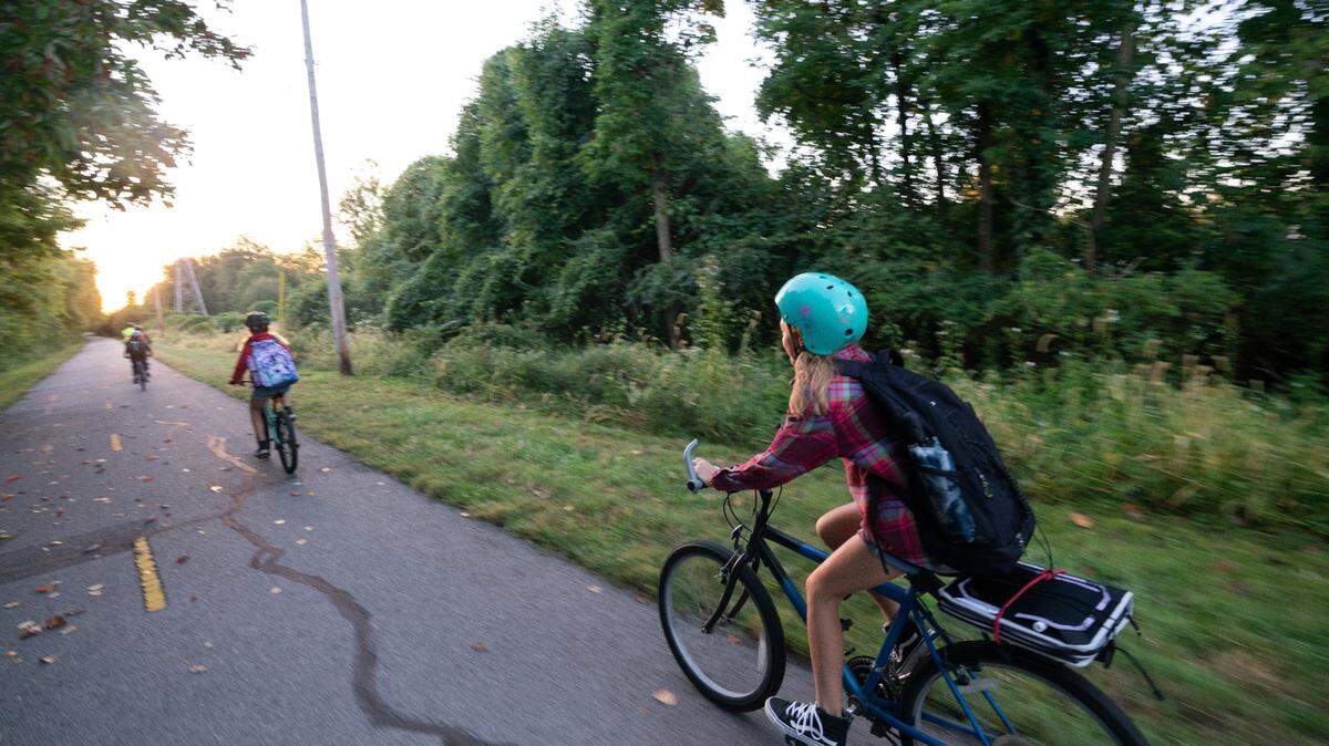 Nathalie speeds to catch up to her friends during a “bike bus” in Edwardsville, Ill. on Oct. 6, 2023.