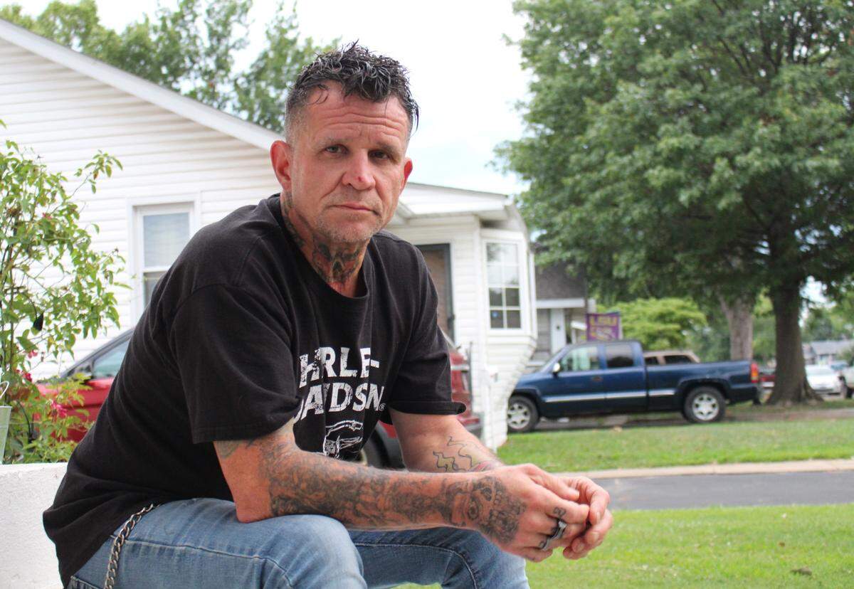 Robert Hamor, 56, sits on his front stoop in East Alton, where his son, Bailey Hamor, lived before he was arrested for allegedly stabbing to death a man in unincorporated Belleville on July 20.