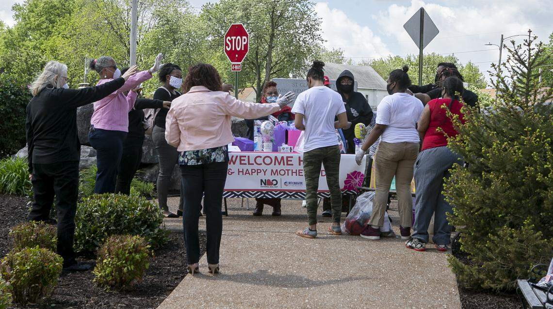 A prayer is made for the three women at right after they were released from the St. Clair County Jail. Members of United Congregations of Metro East (UCM), and National Bail Out Collective (NBO) worked together to unite three mothers with their families for Mother’s Day. The three mothers were in the St. Clair County Jail and could not afford to pay their bond. The groups paid the bond to get the three released in time for Mother’s Day.